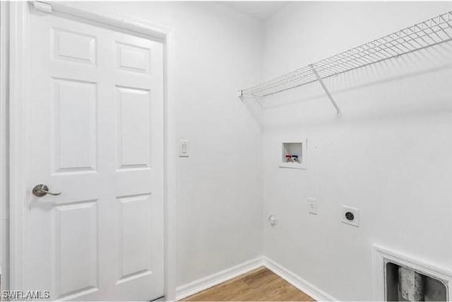 609 SW 22nd St, Cape Coral, FL 33991 - laundry area featuring electric dryer hookup, washer hookup, and wood finished floors