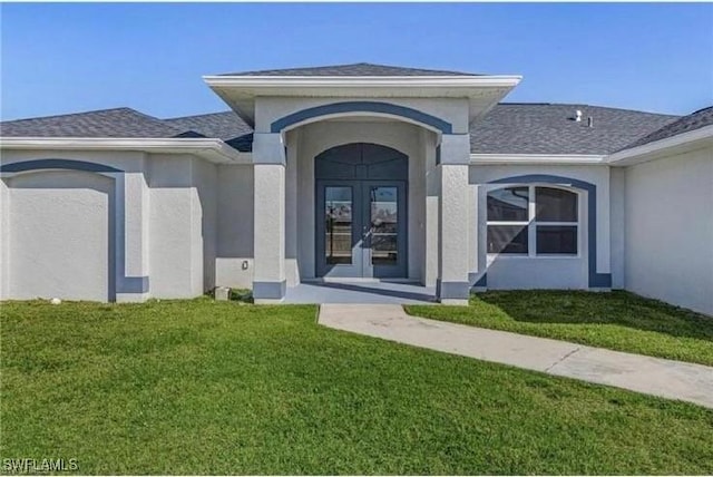 609 SW 22nd St, Cape Coral, FL 33991 - entrance to property with a lawn, french doors, stucco siding, and roof with shingles