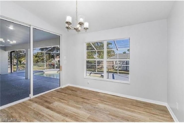 609 SW 22nd St, Cape Coral, FL 33991 - unfurnished dining area featuring a chandelier and wood finished floors