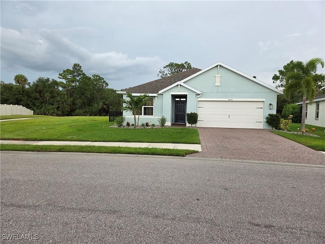 8868 E Cascade Price Cir, North Fort Myers, FL 33917 - single story home featuring decorative driveway, an attached garage, a front yard, and stucco siding