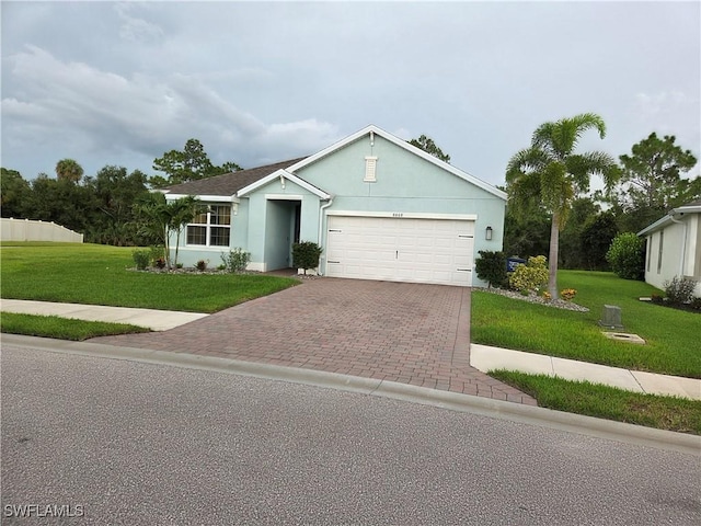 8868 E Cascade Price Cir, North Fort Myers, FL 33917 - ranch-style house featuring decorative driveway, a front yard, an attached garage, and stucco siding