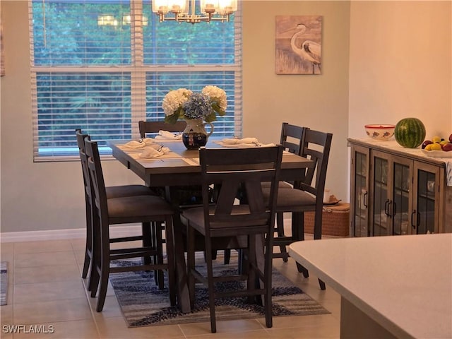 8868 E Cascade Price Cir, North Fort Myers, FL 33917 - tiled dining space featuring a chandelier and baseboards