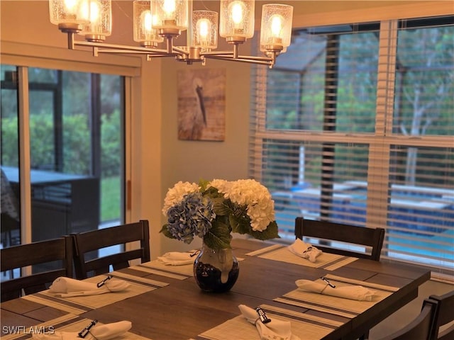 8868 E Cascade Price Cir, North Fort Myers, FL 33917 - dining room featuring a chandelier and wood finished floors