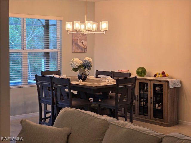 8868 E Cascade Price Cir, North Fort Myers, FL 33917 - tiled dining area featuring a chandelier and baseboards