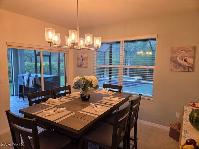 8868 E Cascade Price Cir, North Fort Myers, FL 33917 - dining room featuring a chandelier, tile patterned floors, and vaulted ceiling