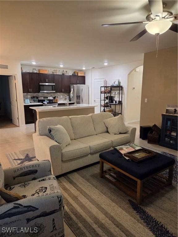 8868 E Cascade Price Cir, North Fort Myers, FL 33917 - living area with arched walkways, recessed lighting, and ceiling fan