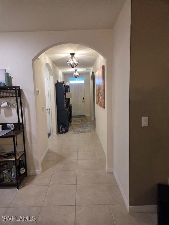 8868 E Cascade Price Cir, North Fort Myers, FL 33917 - corridor featuring arched walkways and light tile patterned floors