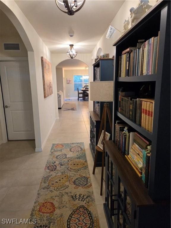 8868 E Cascade Price Cir, North Fort Myers, FL 33917 - corridor featuring arched walkways and light tile patterned floors