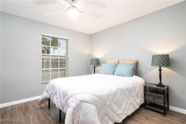 9580 Victoria Ln Unit A106, Naples, FL 34109 - bedroom with wood finished floors and a ceiling fan