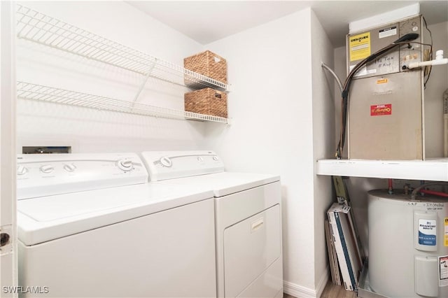 9580 Victoria Ln Unit A106, Naples, FL 34109 - laundry area featuring water heater, washer and clothes dryer, and wood finished floors