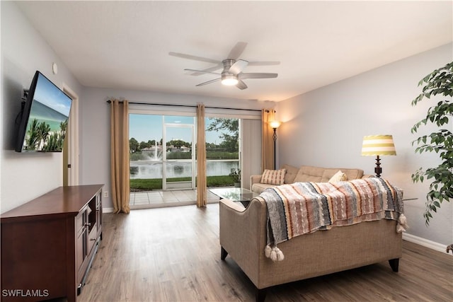 9580 Victoria Ln Unit A106, Naples, FL 34109 - bedroom with access to exterior, light wood finished floors, and a ceiling fan