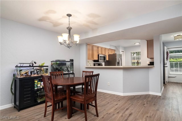 9580 Victoria Ln Unit A106, Naples, FL 34109 - dining space with a chandelier and light wood-type flooring