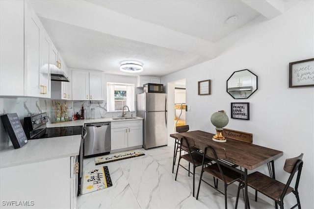 3064 Connecticut Ave, Naples, FL 34112 - kitchen with black appliances, light marble finish floors, light countertops, under cabinet range hood, and white cabinets