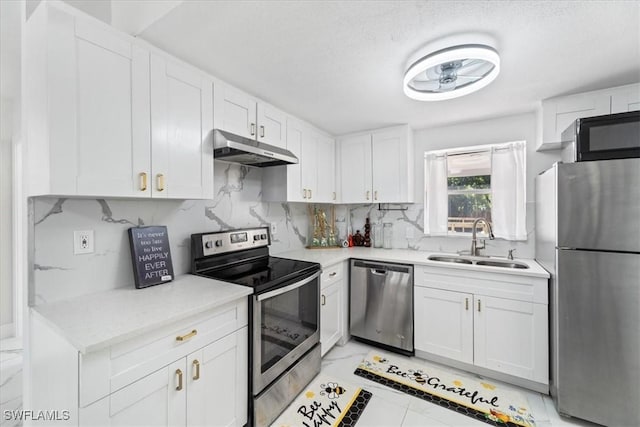 3064 Connecticut Ave, Naples, FL 34112 - kitchen with appliances with stainless steel finishes, under cabinet range hood, backsplash, white cabinets, and light countertops