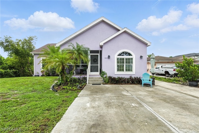 4440 40th St NE, Naples, FL 34120 - ranch-style home with a front lawn and stucco siding