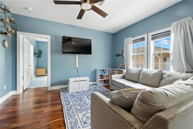 4440 40th St NE, Naples, FL 34120 - living room featuring a ceiling fan and dark wood-style floors