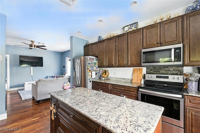 4440 40th St NE, Naples, FL 34120 - kitchen featuring stainless steel appliances, open floor plan, a ceiling fan, dark wood-style flooring, and dark brown cabinets