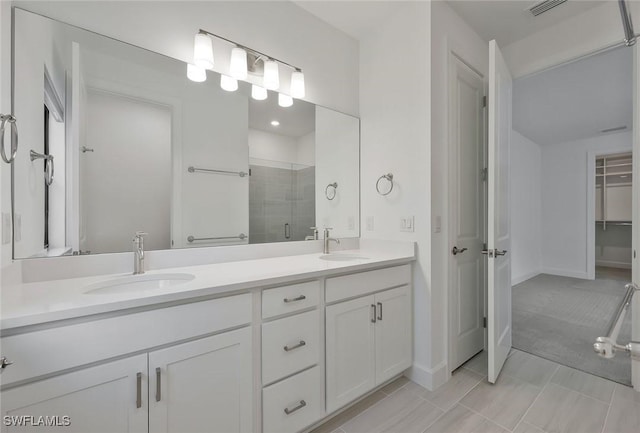 4184 Sonoma Oaks Cir, Naples, FL 34119 - bathroom with a shower stall, double vanity, and a walk in closet
