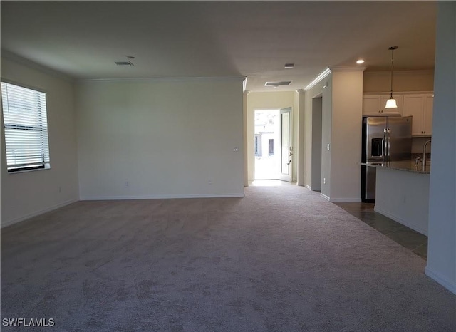 9238 Shadow Oak Ln, Naples, FL 34120 - unfurnished living room featuring crown molding and dark carpet