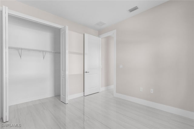 2717 10th Ave SE, Naples, FL 34117 - unfurnished bedroom featuring baseboards and a closet