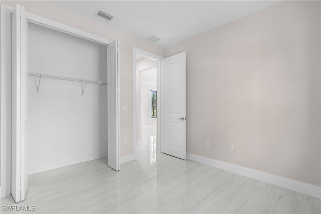2717 10th Ave SE, Naples, FL 34117 - unfurnished bedroom with a closet and baseboards