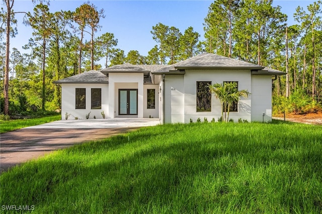 2717 10th Ave SE, Naples, FL 34117 - rear view of house featuring french doors, stucco siding, and a shingled roof