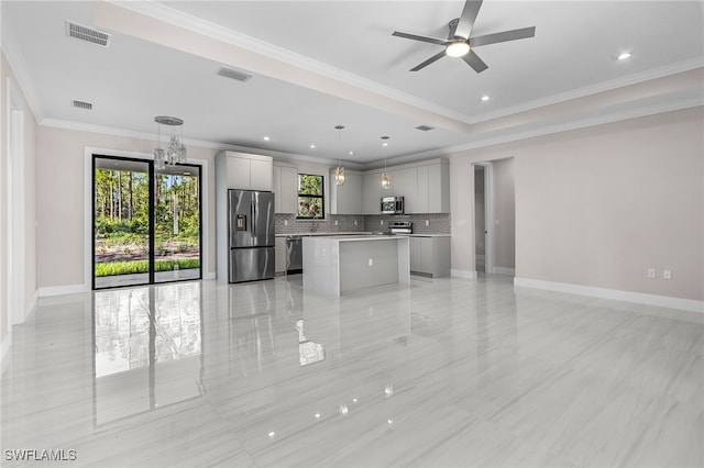 2717 10th Ave SE, Naples, FL 34117 - kitchen featuring appliances with stainless steel finishes, backsplash, a kitchen island, open floor plan, and gray cabinetry