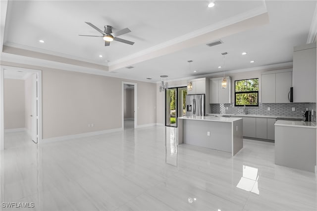 2717 10th Ave SE, Naples, FL 34117 - kitchen featuring gray cabinetry, stainless steel fridge with ice dispenser, ornamental molding, a kitchen island, and open floor plan