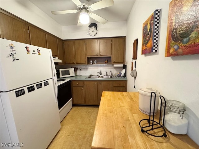 13150 Kings Point Dr Unit 11C, Fort Myers, FL 33919 - kitchen featuring white appliances, light floors, decorative backsplash, open shelves, and a ceiling fan