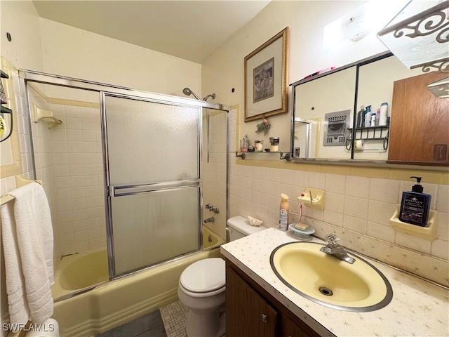13150 Kings Point Dr Unit 11C, Fort Myers, FL 33919 - bathroom featuring vanity, combined bath / shower with glass door, tile patterned flooring, and tile walls