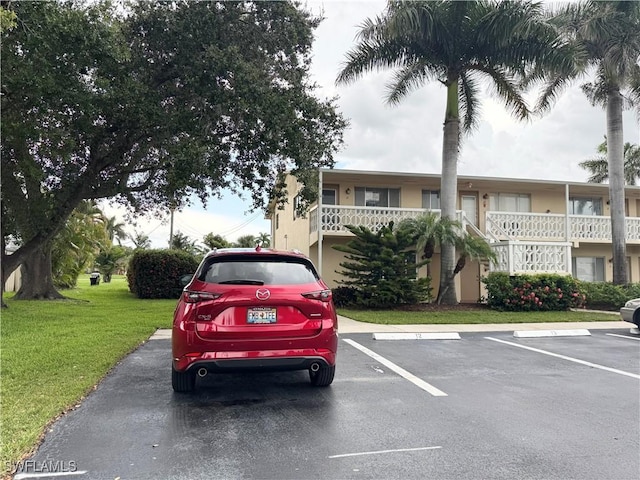 13150 Kings Point Dr Unit 11C, Fort Myers, FL 33919 - view of front of property with uncovered parking and a front yard
