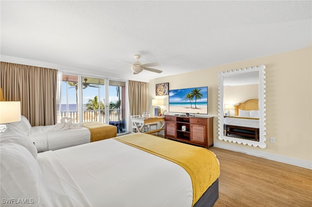 140 Estero Blvd Unit 2209, Fort Myers Beach, FL 33931 - bedroom with access to exterior, wood finished floors, a textured ceiling, and ceiling fan