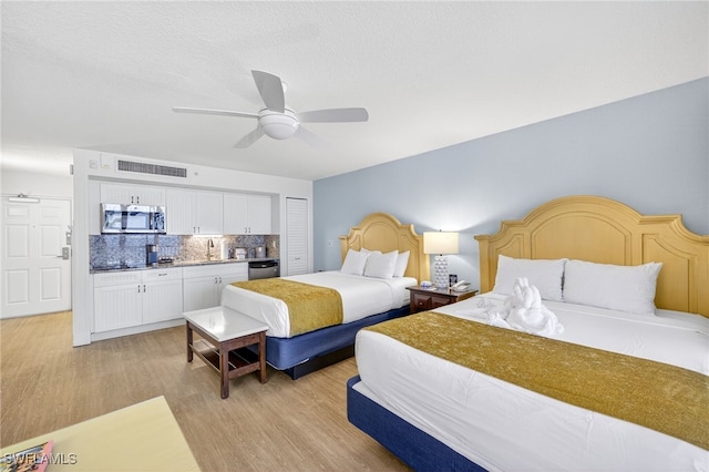 140 Estero Blvd Unit 2209, Fort Myers Beach, FL 33931 - bedroom with bar with sink, light wood-style flooring, and ceiling fan