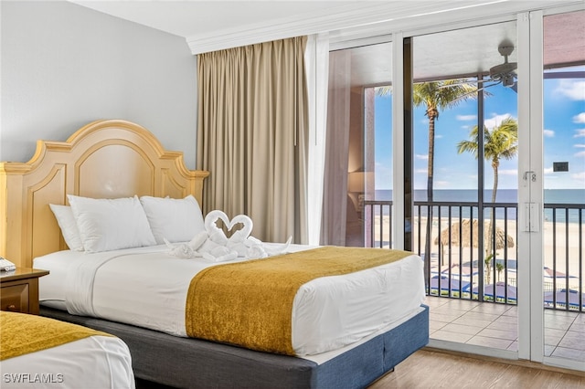 140 Estero Blvd Unit 2209, Fort Myers Beach, FL 33931 - bedroom with a water view, access to outside, wood finished floors, expansive windows, and ornamental molding