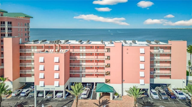 140 Estero Blvd Unit 2209, Fort Myers Beach, FL 33931 - view of apartment building / complex with a water view and uncovered parking