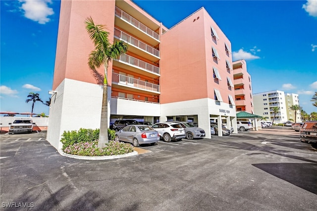 140 Estero Blvd Unit 2209, Fort Myers Beach, FL 33931 - view of apartment building / complex featuring uncovered parking