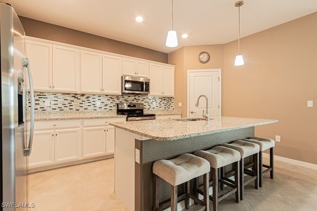 3943 E Hampton Cir, Alva, FL 33920 - kitchen with appliances with stainless steel finishes, decorative backsplash, light tile patterned floors, white cabinets, and pendant lighting