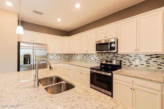 3943 E Hampton Cir, Alva, FL 33920 - kitchen with appliances with stainless steel finishes, tasteful backsplash, hanging light fixtures, recessed lighting, and white cabinetry