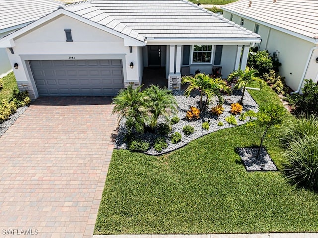 3943 E Hampton Cir, Alva, FL 33920 - ranch-style house with an attached garage, a tiled roof, and stucco siding