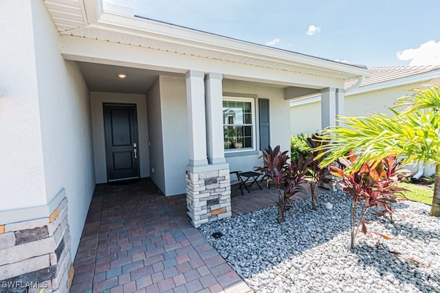 3943 E Hampton Cir, Alva, FL 33920 - doorway to property featuring stucco siding and covered porch