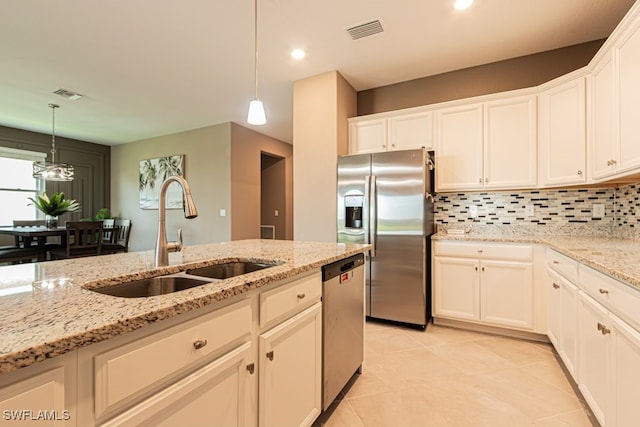 3943 E Hampton Cir, Alva, FL 33920 - kitchen with stainless steel appliances, backsplash, white cabinets, hanging light fixtures, and recessed lighting