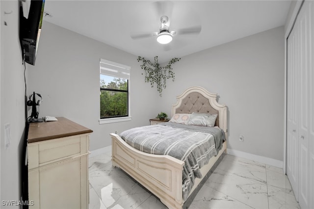4267 4th Ave SE, Naples, FL 34117 - bedroom with light marble finish floors, a closet, and a ceiling fan