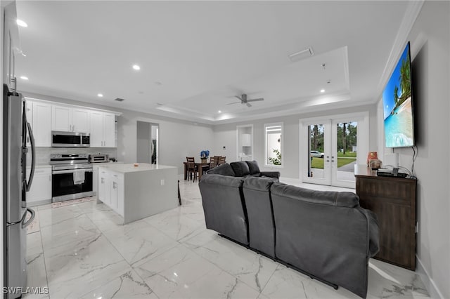 4267 4th Ave SE, Naples, FL 34117 - living room with a raised ceiling, a ceiling fan, recessed lighting, light marble finish floors, and french doors