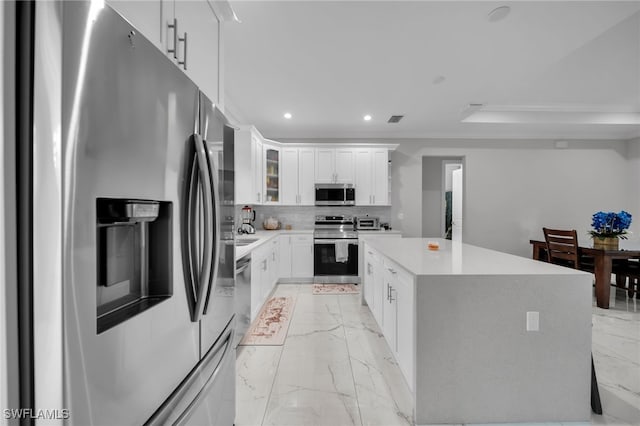 4267 4th Ave SE, Naples, FL 34117 - kitchen featuring appliances with stainless steel finishes, light marble finish floors, recessed lighting, a center island, and light countertops