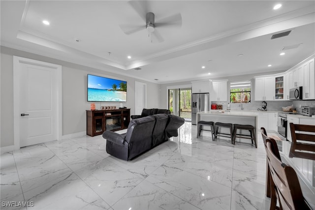 4267 4th Ave SE, Naples, FL 34117 - living area with crown molding, a ceiling fan, recessed lighting, and a tray ceiling