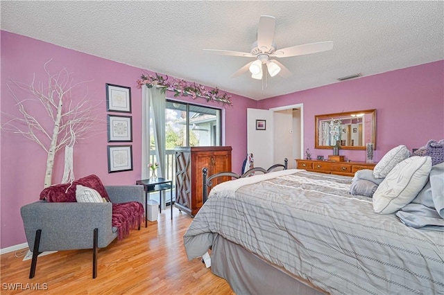 6296 Sugar Bush Ln Unit A, Fort Myers, FL 33908 - bedroom with light wood-type flooring, a textured ceiling, and ceiling fan