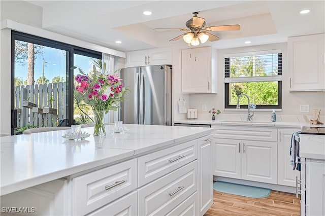 6296 Sugar Bush Ln Unit A, Fort Myers, FL 33908 - kitchen featuring freestanding refrigerator, a tray ceiling, healthy amount of natural light, and recessed lighting