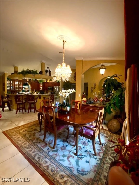 291 Everglades Blvd N, Naples, FL 34120 - dining area featuring tile patterned flooring, arched walkways, and a chandelier