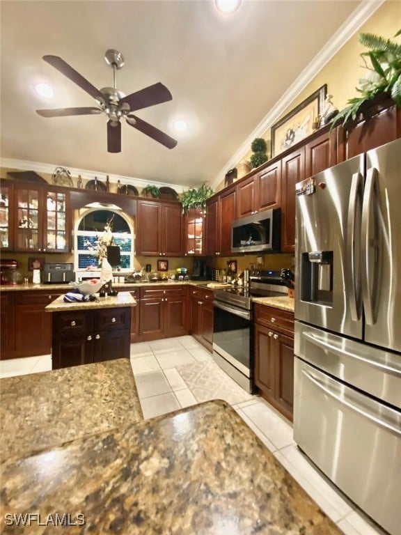 291 Everglades Blvd N, Naples, FL 34120 - kitchen featuring stainless steel appliances, crown molding, ceiling fan, light tile patterned floors, and glass insert cabinets