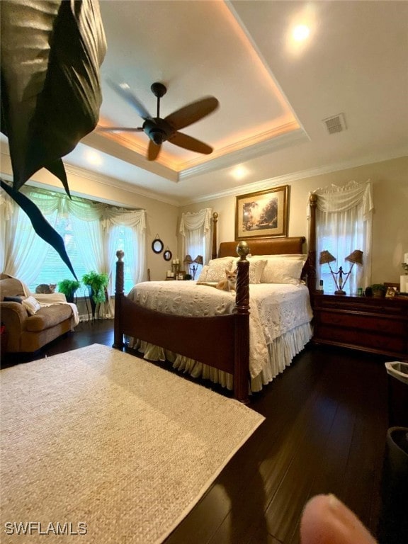 291 Everglades Blvd N, Naples, FL 34120 - bedroom featuring a tray ceiling, ornamental molding, dark wood-style floors, and a ceiling fan